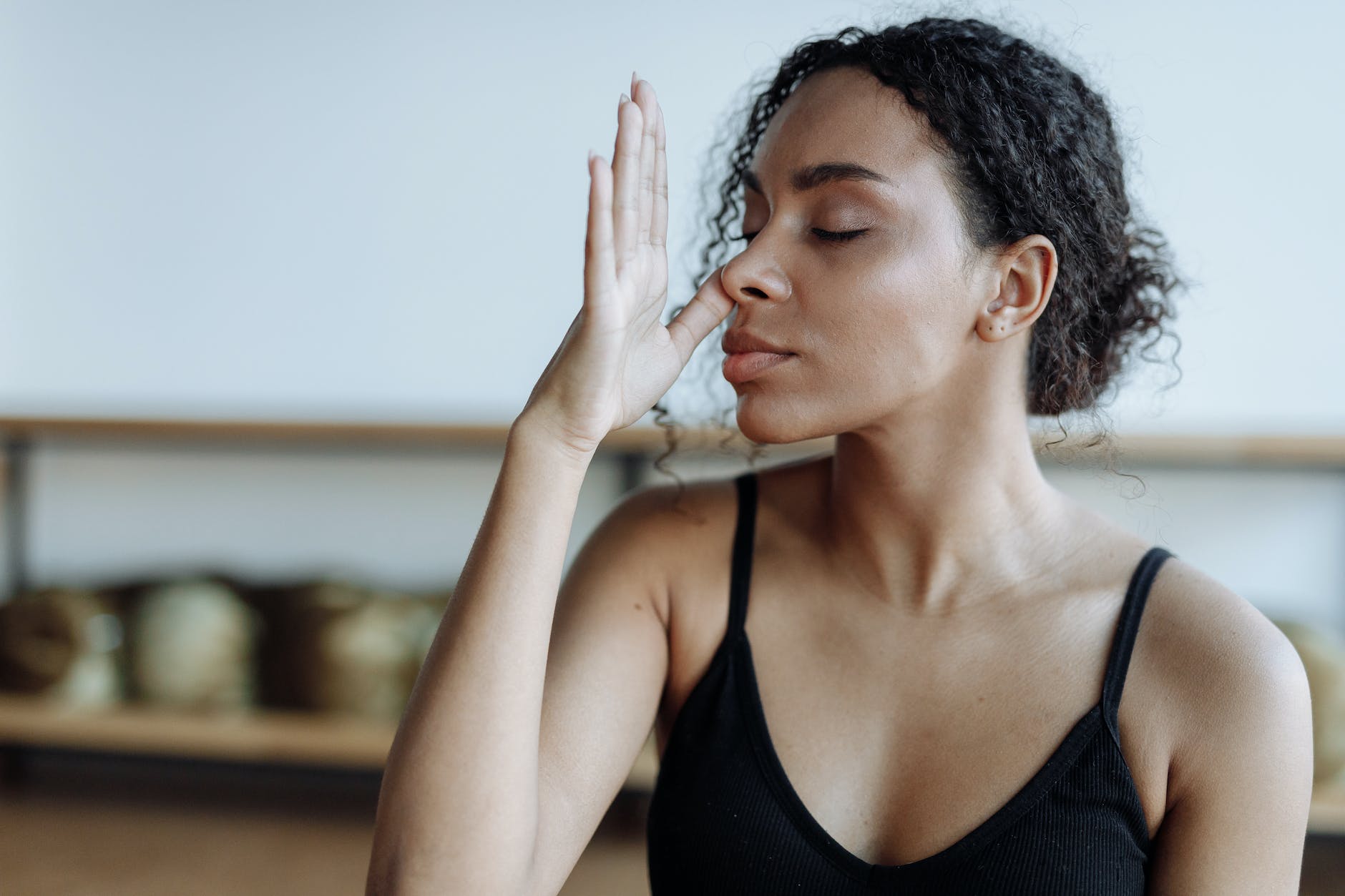 woman in black tank top meditating